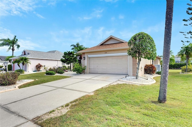 single story home with a garage and a front lawn