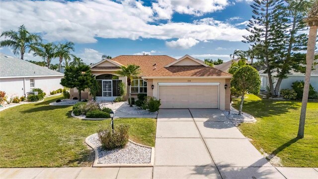 719 Winterbrooke Way, Sun City Center, FL 33573 - ranch-style home featuring stucco siding, an attached garage, a front lawn, and driveway