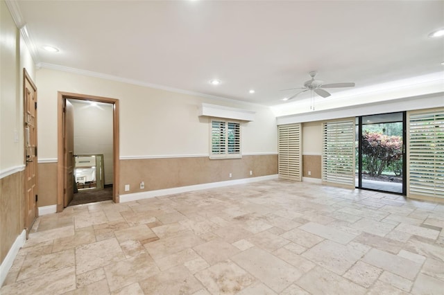 spare room with ornamental molding, wooden walls, and ceiling fan