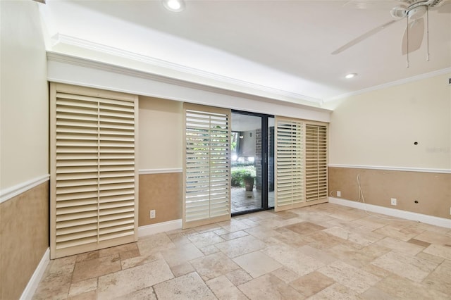 empty room with ceiling fan and crown molding