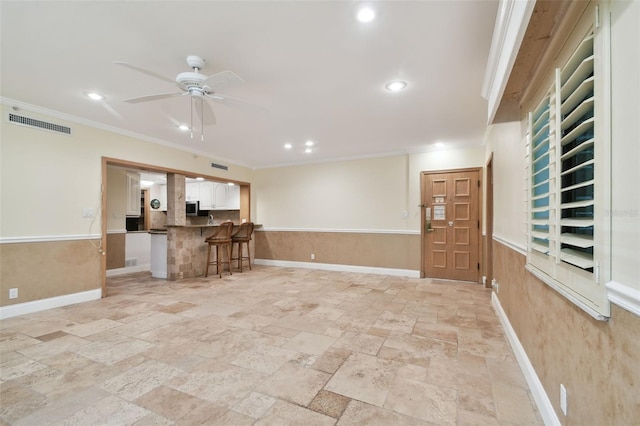 unfurnished living room featuring ornamental molding and ceiling fan