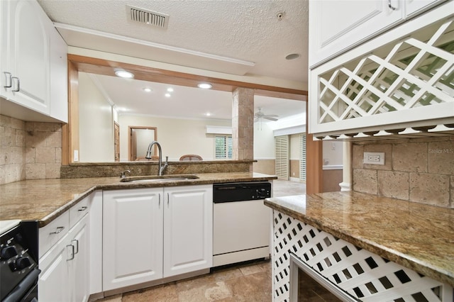 kitchen featuring kitchen peninsula, sink, white dishwasher, and stone countertops