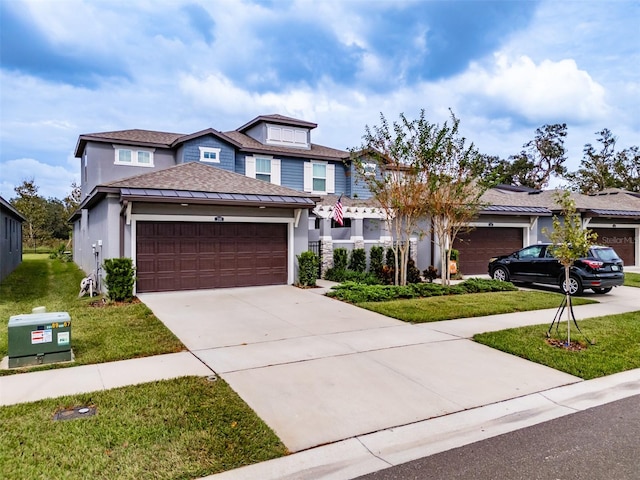 view of front of house with a garage and a front lawn