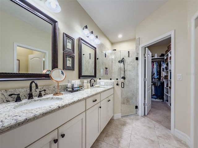 bathroom featuring walk in shower, vanity, and tile patterned floors