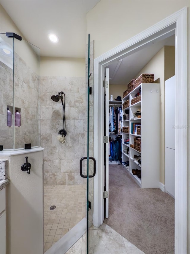 bathroom featuring a shower with shower door