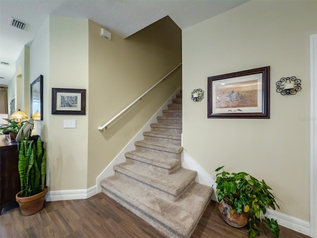 staircase with hardwood / wood-style floors