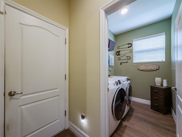 washroom with separate washer and dryer and dark hardwood / wood-style floors