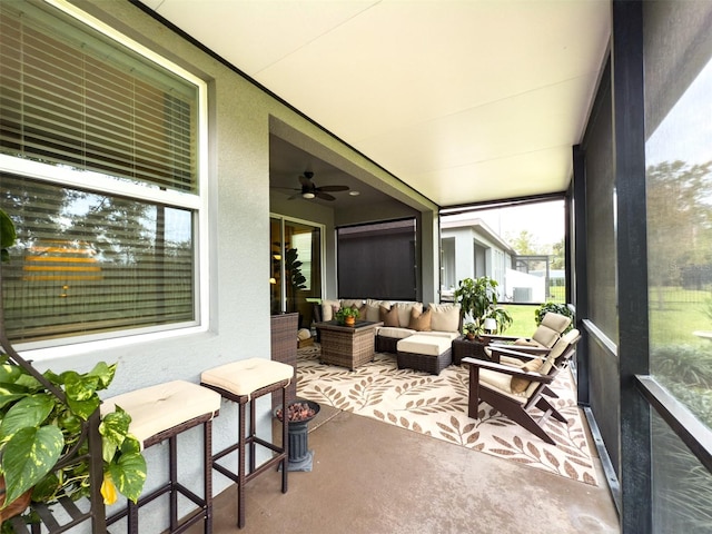 sunroom featuring ceiling fan