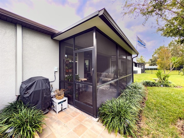 exterior space featuring a sunroom and a yard