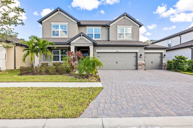 craftsman-style home featuring a garage and a front lawn