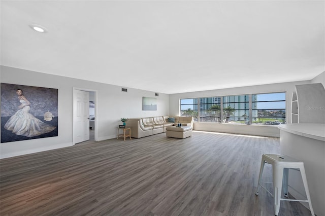 unfurnished living room with dark wood-type flooring