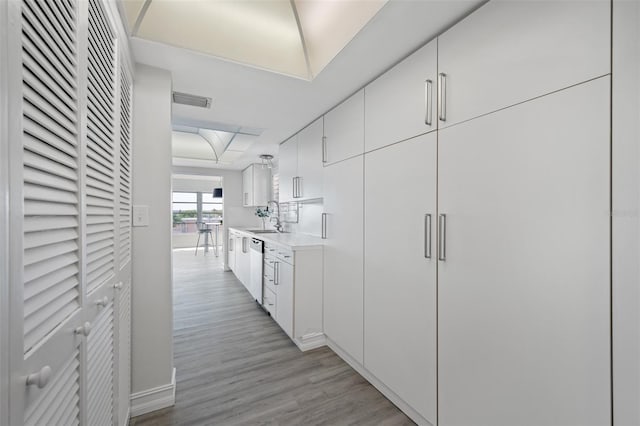 hall featuring light hardwood / wood-style flooring and sink