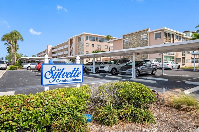 view of parking / parking lot featuring a carport