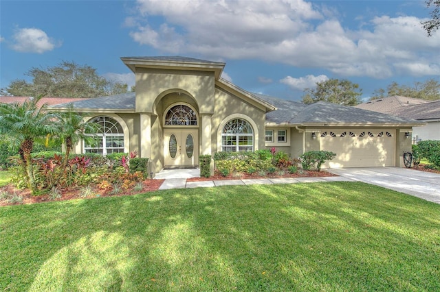 mediterranean / spanish house with french doors, a garage, and a front lawn