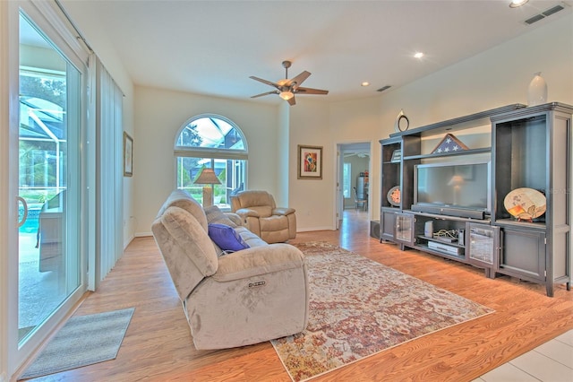 living room featuring light hardwood / wood-style floors and ceiling fan