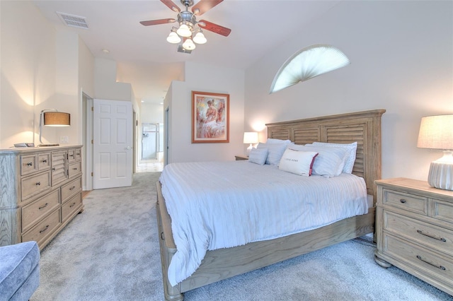 bedroom with light carpet and ceiling fan