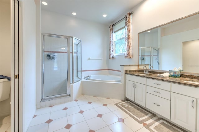 bathroom featuring vanity and shower with separate bathtub