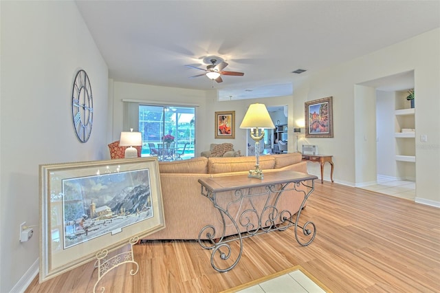 living room featuring ceiling fan and wood-type flooring