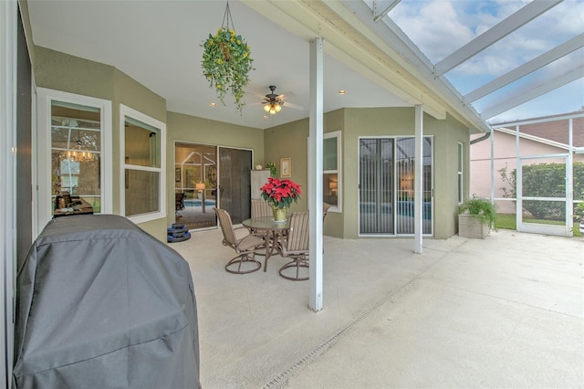 sunroom with ceiling fan and lofted ceiling