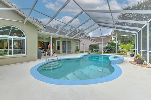 view of pool with a lanai, a patio area, and ceiling fan