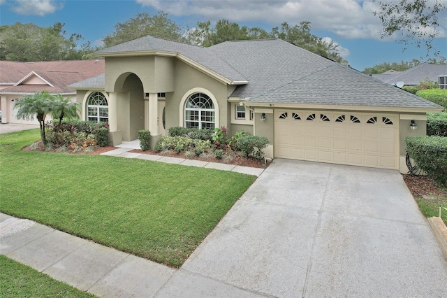 view of front facade featuring a front lawn and a garage