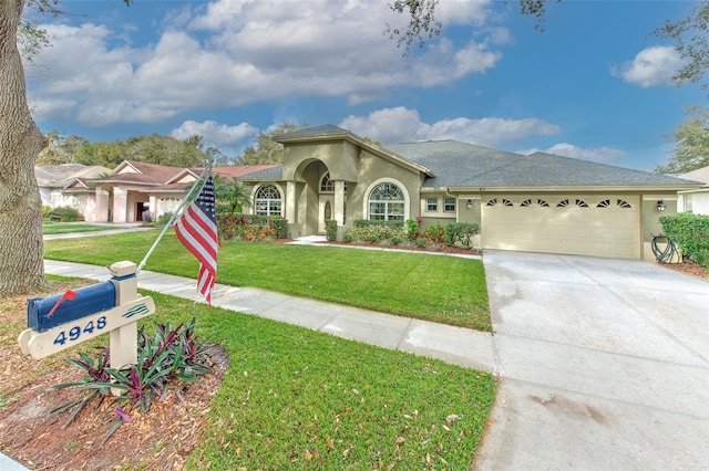 view of front of house with a garage and a front lawn