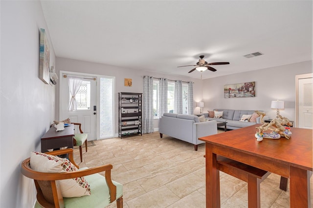 living room featuring a wealth of natural light and ceiling fan