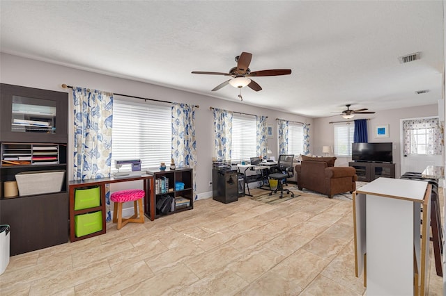 interior space with a textured ceiling and ceiling fan