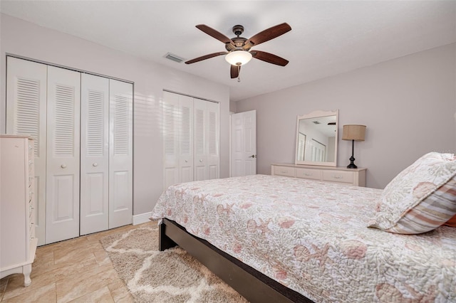 bedroom featuring two closets and ceiling fan