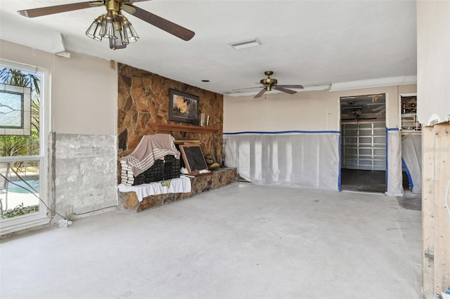 unfurnished living room featuring concrete flooring and ceiling fan