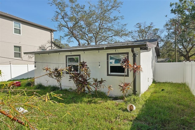 view of property exterior with a yard