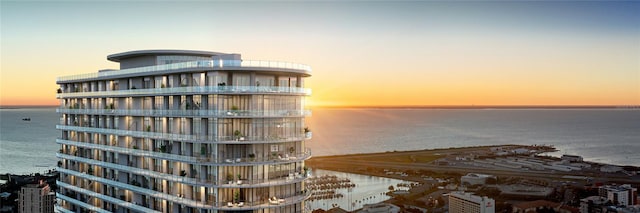 outdoor building at dusk featuring a water view