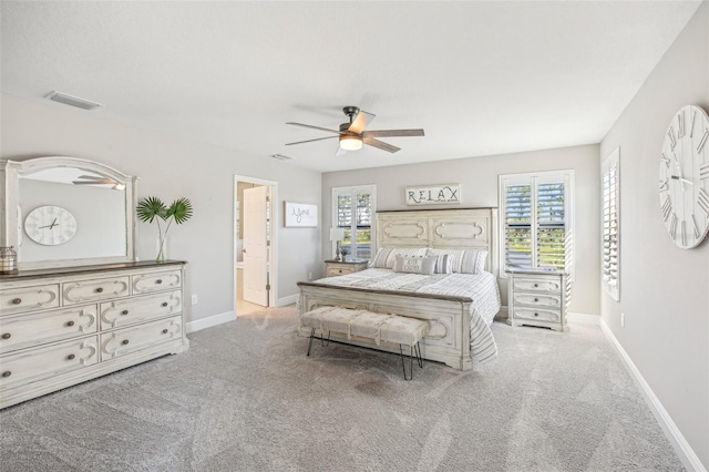 carpeted bedroom with ceiling fan and connected bathroom