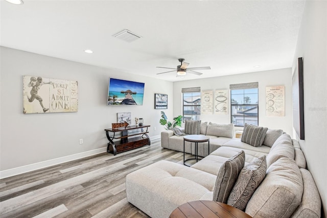 living room featuring ceiling fan and light hardwood / wood-style flooring