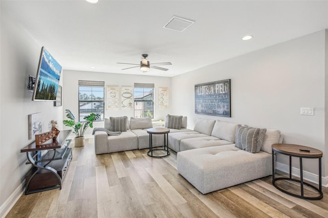 living room with ceiling fan and light wood-type flooring