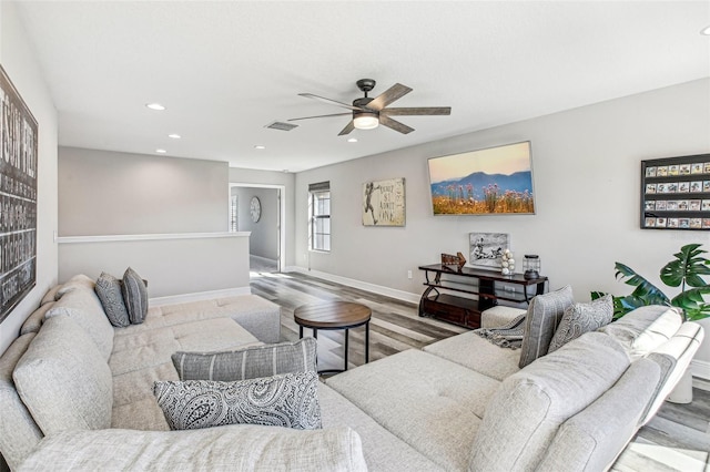 living room featuring ceiling fan and hardwood / wood-style flooring