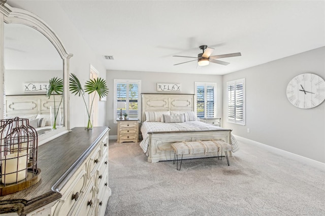 bedroom with ceiling fan and light carpet