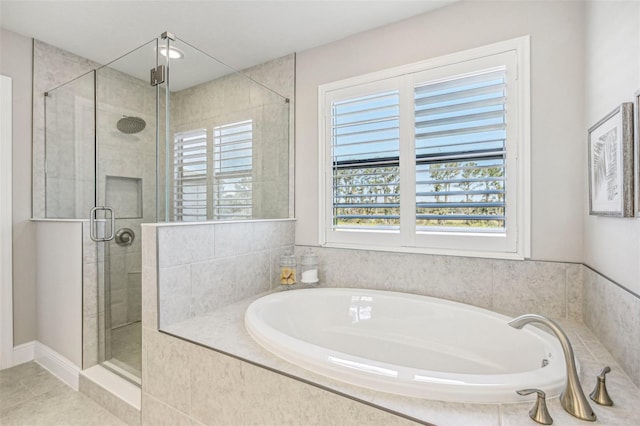 bathroom featuring tile patterned floors and independent shower and bath