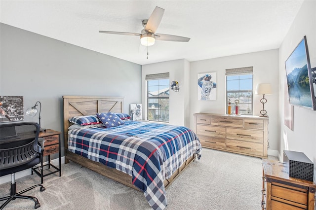 carpeted bedroom with ceiling fan and multiple windows