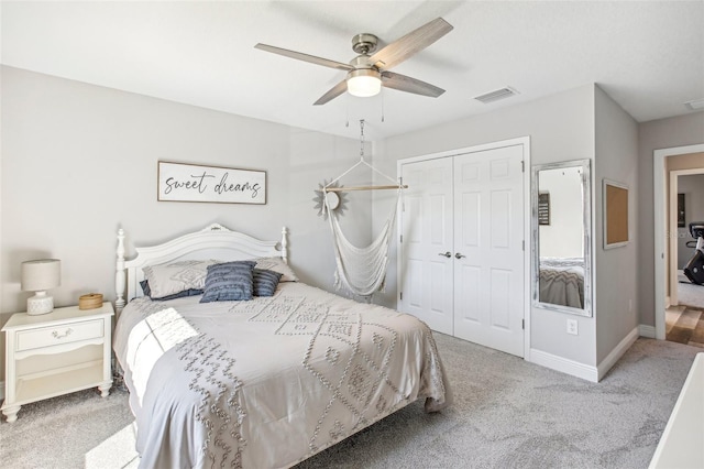 bedroom with ceiling fan, a closet, and carpet floors