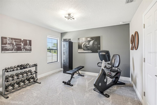 workout room featuring a textured ceiling