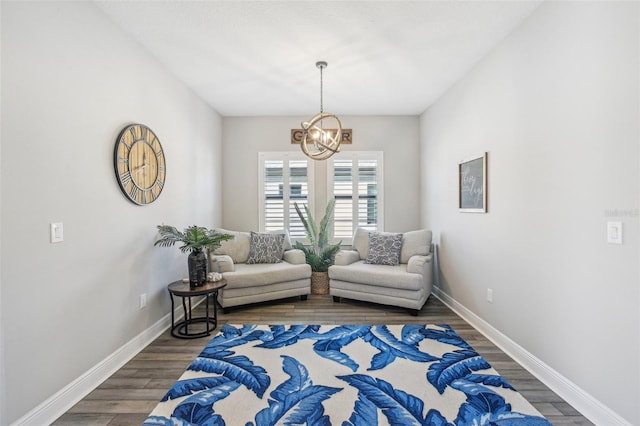 living area featuring dark wood-type flooring and a chandelier