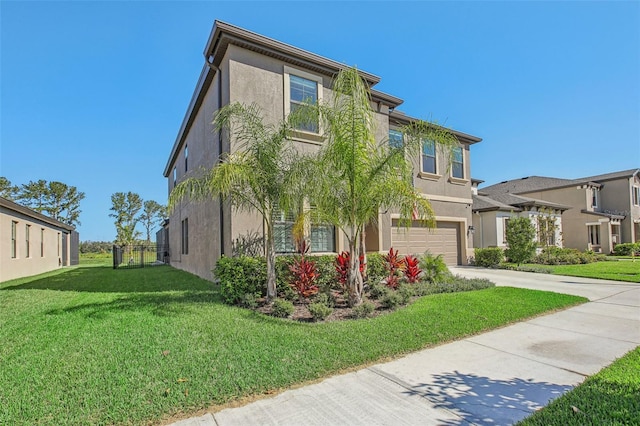 view of front of home featuring a garage and a front lawn