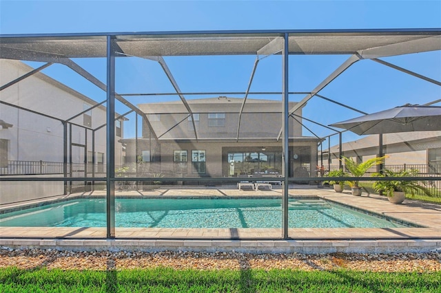 view of swimming pool featuring a patio area and a lanai