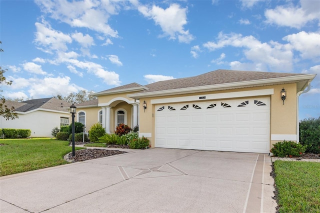 view of front of home with a garage and a front lawn