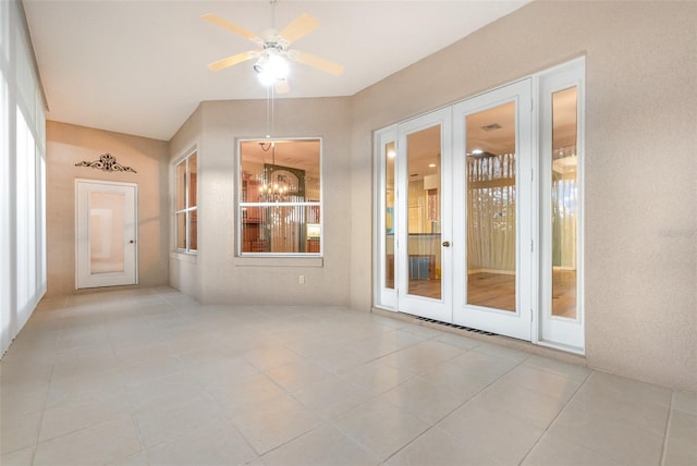 unfurnished room with ceiling fan, light tile patterned floors, and french doors