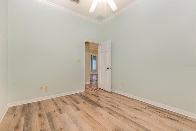 empty room featuring a high ceiling, light wood-type flooring, ceiling fan, and crown molding