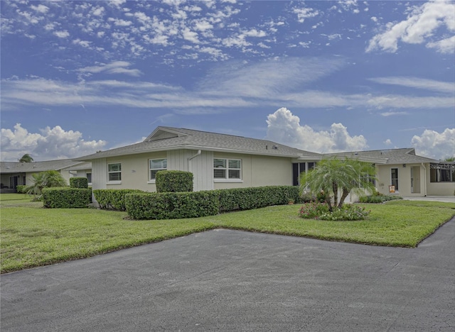 ranch-style house with a front lawn