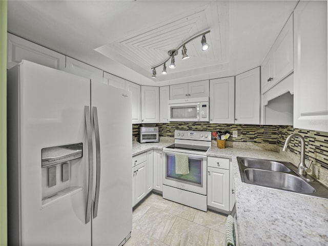 kitchen featuring white cabinetry, sink, white appliances, and backsplash