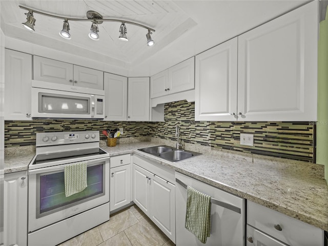 kitchen with track lighting, sink, tasteful backsplash, white cabinetry, and white appliances